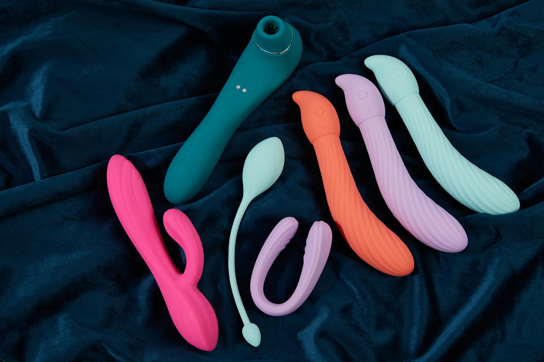 A young couple standing together indoors, exploring intimacy with a vibrator